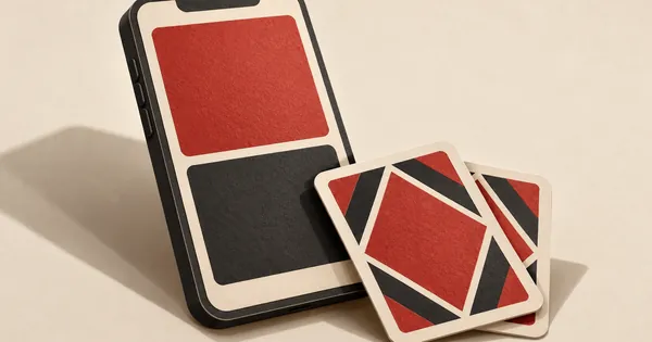 A smartphone with plain colour panels and two face-down playing cards